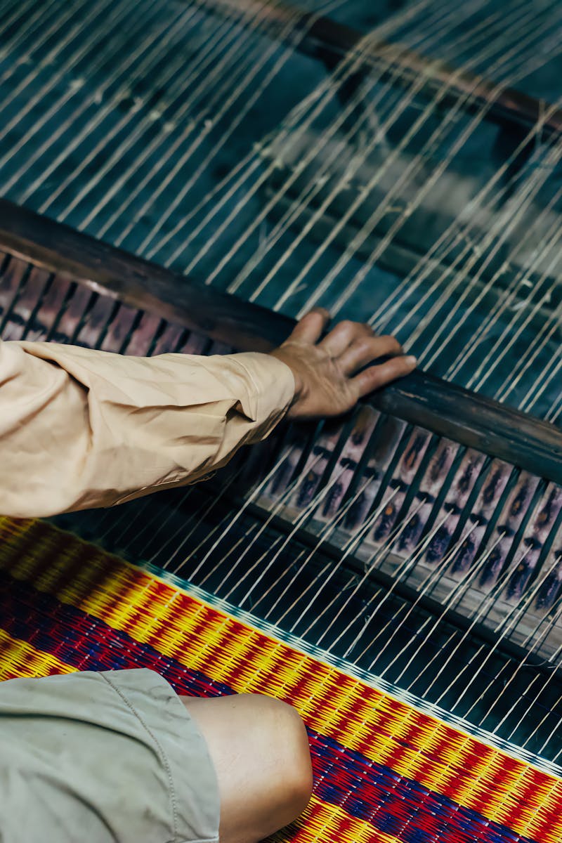 A craftsman weaving on a loom in Hội An, showcasing traditional textile production.